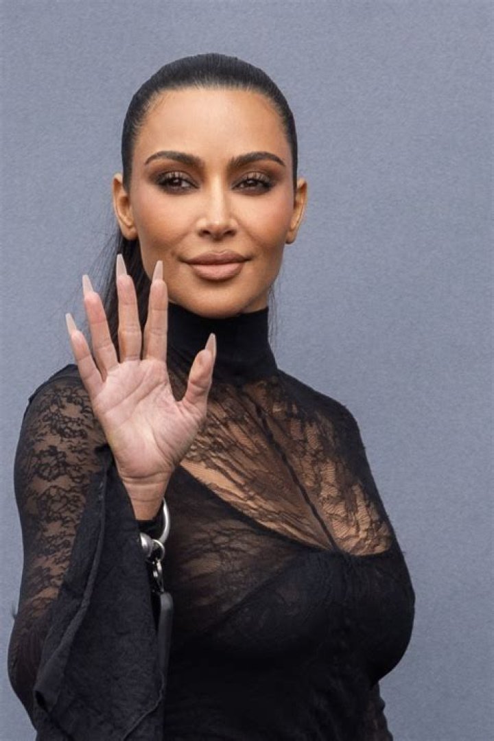 Kim Kardashian Shows Off Lingerie In Plunging Gold Leather Jumpsuit At Milan Fashion Week